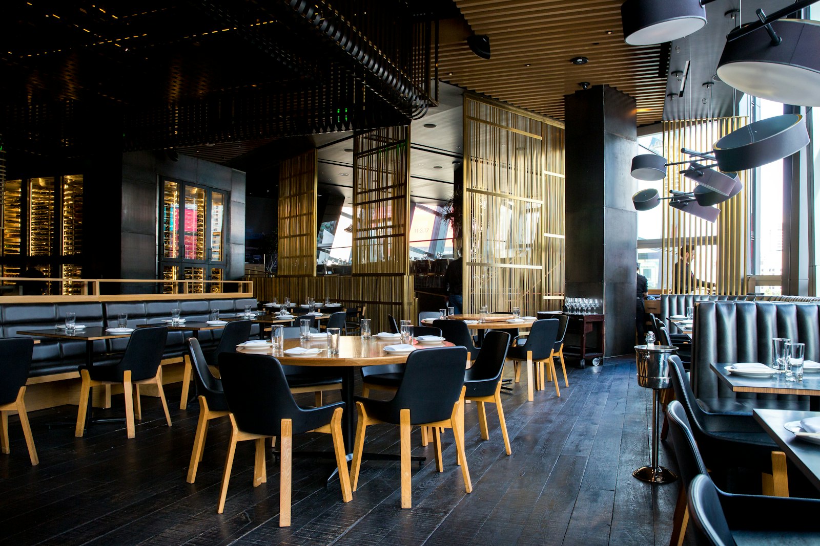 Moody restaurant interior with wine cellar wall
