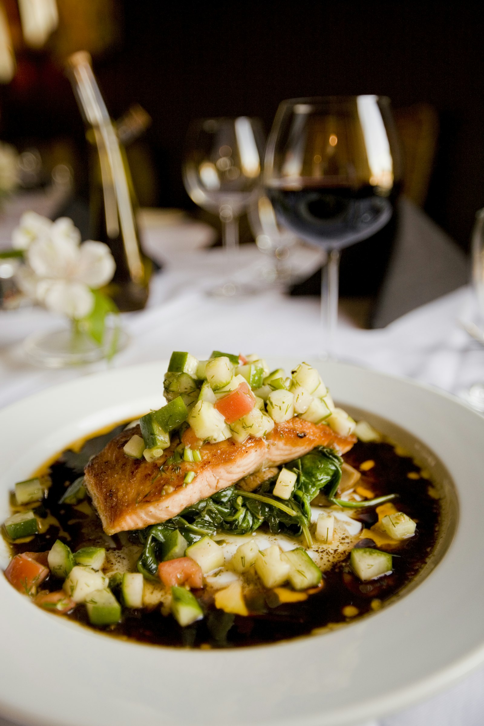 Seared salmon with cucumber-tomato salsa over greens
